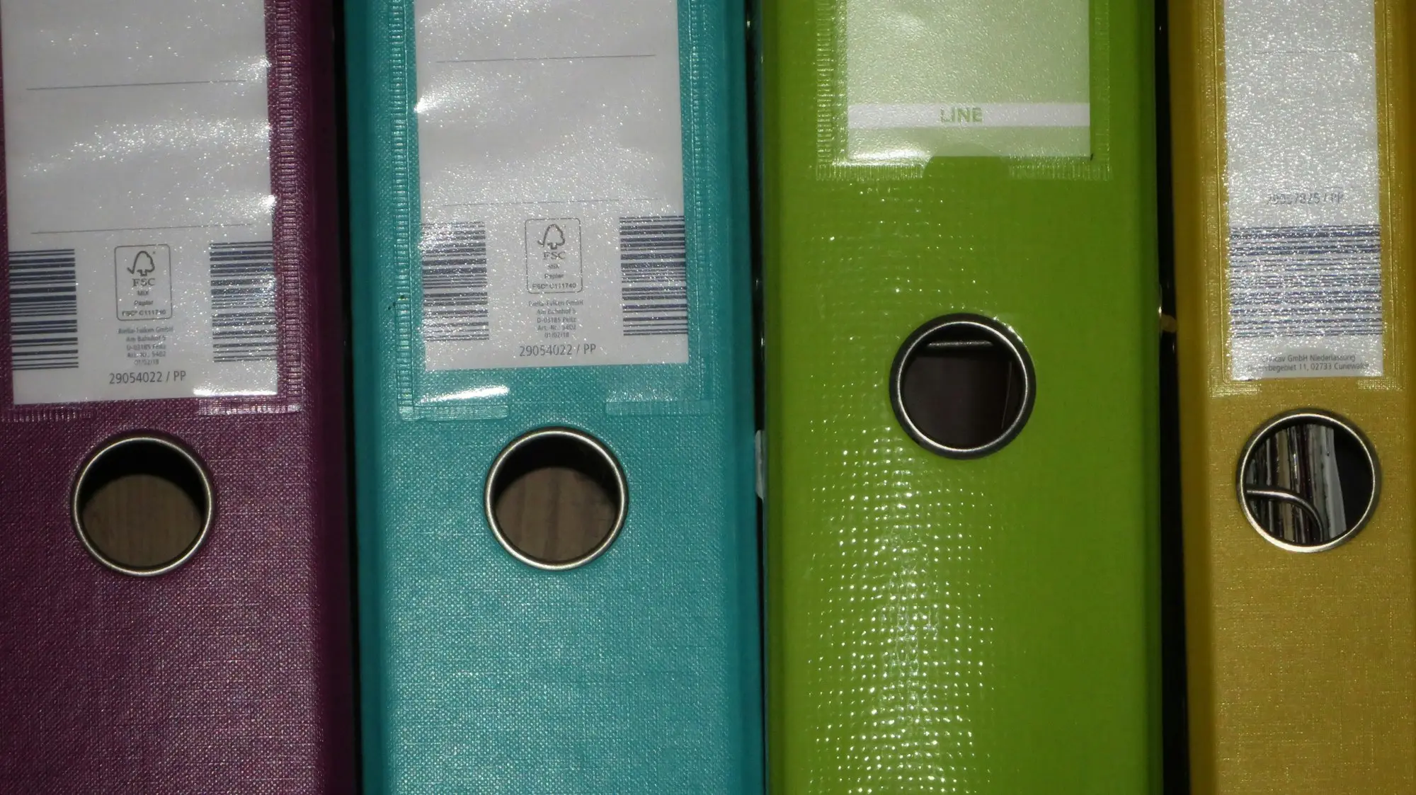 Ring binders lined up on a shelf for loan documents