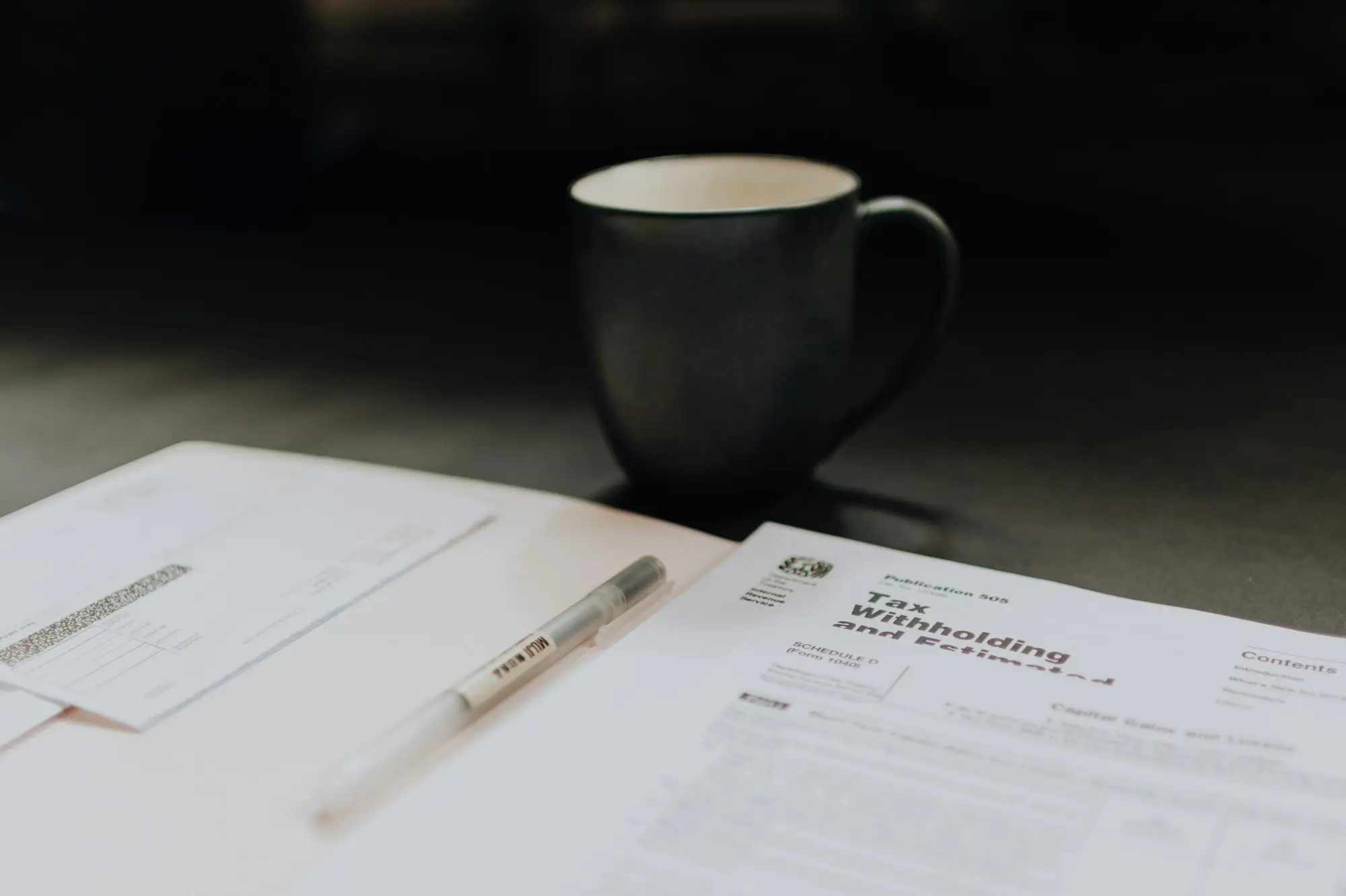 Paperwork and a coffee mug on a desk