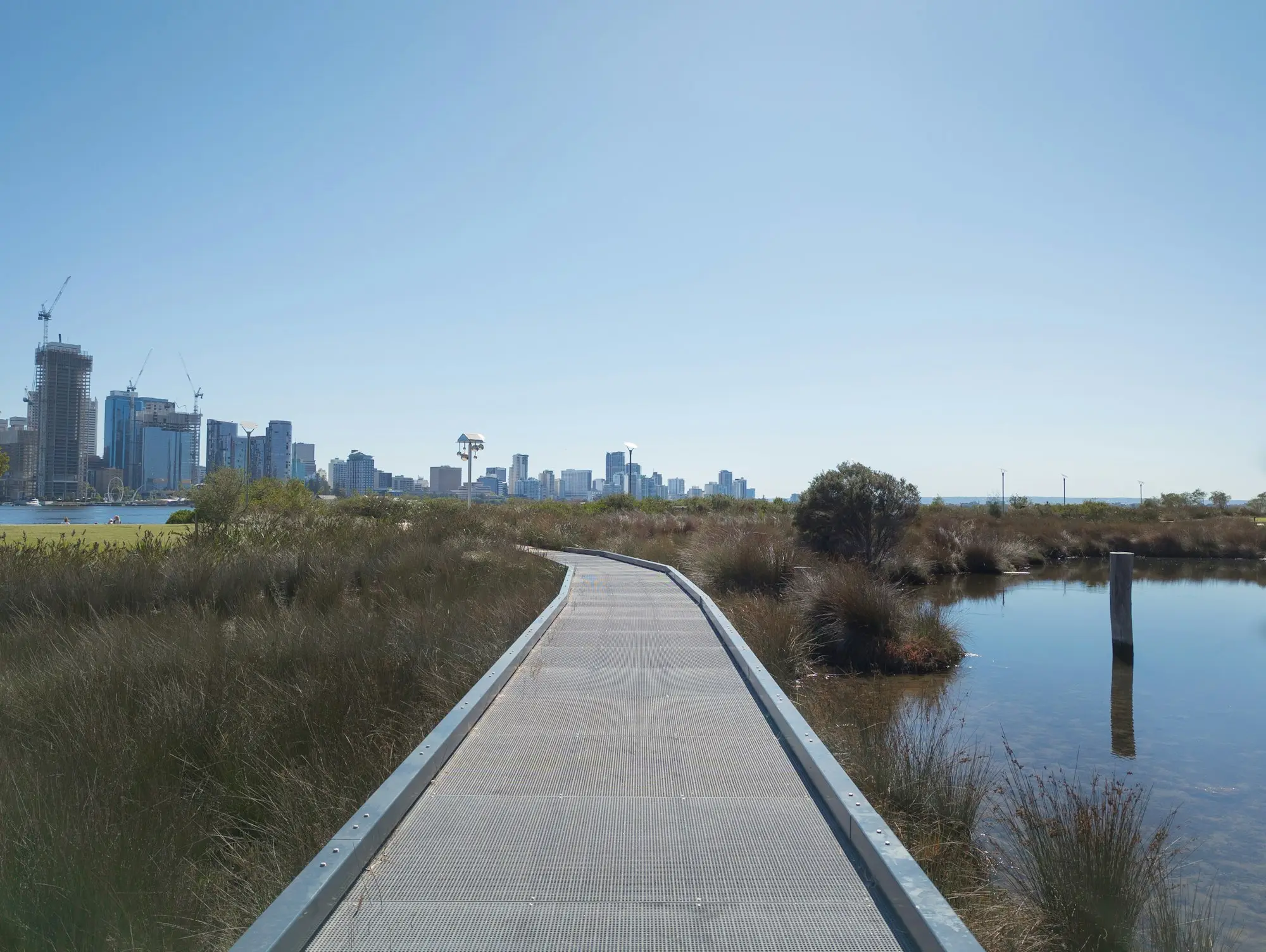 Boardwalk along the Swan River with the Perth skyline beyond